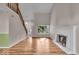 Bright living room with hardwood floors, a cozy fireplace and views of the outdoors at 8908 Sunningdale Blvd, Indianapolis, IN 46234