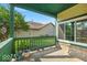 Cozy front porch features green railings and offers space for relaxation at 8908 Sunningdale Blvd, Indianapolis, IN 46234