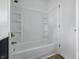 Bathroom showcasing the shower/tub combo with white tiled walls and fixtures at 903 Sunset Dr, Lebanon, IN 46052