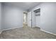 Bedroom with neutral carpet, closet with shelves, and a door to the hallway at 903 Sunset Dr, Lebanon, IN 46052