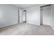 Bedroom with neutral carpet, showing closet with shelves, and a door to the hallway at 903 Sunset Dr, Lebanon, IN 46052