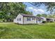 A well-maintained home with blue shutters and a spacious yard is perfect for outdoor activities at 903 Sunset Dr, Lebanon, IN 46052