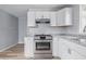 The kitchen features modern stainless steel appliances, white cabinets, and neutral countertops at 903 Sunset Dr, Lebanon, IN 46052