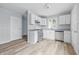 Modern kitchen with white cabinets, stainless steel appliances, and new floors offers style and convenience at 903 Sunset Dr, Lebanon, IN 46052