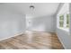 A bright and airy living room is enhanced by large windows and modern flooring at 903 Sunset Dr, Lebanon, IN 46052