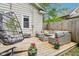 Cozy backyard deck featuring lounge set, egg chair, and potted flowers at 923 42Nd St, Indianapolis, IN 46205