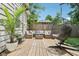 Relaxing backyard deck featuring lounge set, egg chair, potted plants, and wood fence at 923 42Nd St, Indianapolis, IN 46205