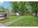 Backyard featuring shed, wood fence, egg chair on deck, and green lawn at 923 42Nd St, Indianapolis, IN 46205