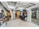 Unfinished basement with exposed ceiling, concrete floors, and storage racks, offering potential for customization at 923 42Nd St, Indianapolis, IN 46205