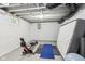 Unfinished basement featuring gym equipment, concrete walls and floors, offering an exercise area at 923 42Nd St, Indianapolis, IN 46205