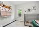 Cozy bedroom featuring a stylish shelf with decorative items, framed artwork, and a comfortable dog crate with a plush bed at 923 42Nd St, Indianapolis, IN 46205