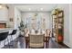 Open dining room features hardwood floors, a large table, natural light, and seamless access to the kitchen at 923 42Nd St, Indianapolis, IN 46205