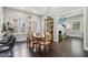 Open dining room features hardwood floors, a large table, natural light, and seamless access to the living room at 923 42Nd St, Indianapolis, IN 46205