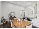 Open dining room features hardwood floors, a large table, natural light, and seamless access to the kitchen at 923 42Nd St, Indianapolis, IN 46205