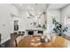 Open dining room features hardwood floors, a large table, natural light, and seamless access to the kitchen at 923 42Nd St, Indianapolis, IN 46205