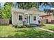 Adorable bungalow featuring a covered front porch, manicured landscaping and inviting walkway at 923 42Nd St, Indianapolis, IN 46205