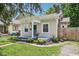 Lovely single-story home with manicured lawn, inviting front porch, and lush landscaping at 923 42Nd St, Indianapolis, IN 46205