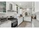 Bright kitchen features white cabinets, subway tile backsplash, stainless steel appliances, and light countertops at 923 42Nd St, Indianapolis, IN 46205