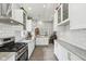 Bright kitchen features white cabinets, subway tile backsplash, stainless steel appliances, and light countertops at 923 42Nd St, Indianapolis, IN 46205