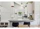 Modern kitchen with white cabinets, bar seating, and stylish lighting at 923 42Nd St, Indianapolis, IN 46205