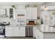 Bright kitchen features white cabinets, subway tile backsplash, stainless steel appliances, and light countertops at 923 42Nd St, Indianapolis, IN 46205