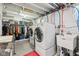 Spacious laundry room featuring a washer and dryer, ample storage with shelving, and a utility sink for added convenience at 923 42Nd St, Indianapolis, IN 46205