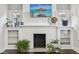 Bright living room with painted fireplace and built-in shelving provides cozy charm at 923 42Nd St, Indianapolis, IN 46205