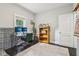 Bright office with a modern desk setup, a comfortable chair, and a wooden bookcase with greenery, offering an inspiring workspace at 923 42Nd St, Indianapolis, IN 46205