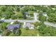 Aerial view of neighborhood showcasing a well-maintained lawn, mature trees, and surrounding residential streets at 10502 E Lakeshore Dr, Carmel, IN 46033
