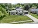 An aerial view showcases this beautiful home, its manicured lawn, mature trees, and surrounding neighborhood at 10502 E Lakeshore Dr, Carmel, IN 46033