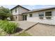 Exterior view of home with concrete patio, siding, stone accents, gravel area, and manicured landscaping at 10502 E Lakeshore Dr, Carmel, IN 46033