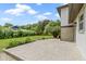 Large backyard and home featuring a concrete patio, lush greenery, and well-maintained lawn at 10502 E Lakeshore Dr, Carmel, IN 46033