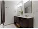 Modern bathroom featuring double vanity with gold fixtures, bright lighting, and decorative mirrors at 10502 E Lakeshore Dr, Carmel, IN 46033