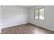 Bright bedroom with wood-look floors and a window at 10502 E Lakeshore Dr, Carmel, IN 46033