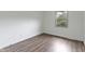 A bright bedroom with modern vinyl floors and a large window at 10502 E Lakeshore Dr, Carmel, IN 46033