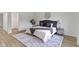 Beautifully staged bedroom with a large bed, stylish rug, and ample natural light at 10502 E Lakeshore Dr, Carmel, IN 46033
