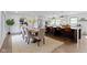 Open-concept kitchen and dining area with updated cabinetry, stainless steel appliances, and seating at island at 10502 E Lakeshore Dr, Carmel, IN 46033