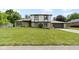 Charming two-story home featuring stone accents, gray shingles, a well-manicured lawn, and attached garage at 10502 E Lakeshore Dr, Carmel, IN 46033