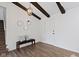 Inviting foyer with wood floors, a bench, decorative mirrors, dark beams and access to the stairs at 10502 E Lakeshore Dr, Carmel, IN 46033