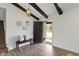 Inviting foyer with wood floors, a bench, decorative mirrors, dark beams and access to the stairs at 10502 E Lakeshore Dr, Carmel, IN 46033