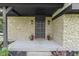 An inviting front entrance with a decorative door, stone facade, and potted plants at 10502 E Lakeshore Dr, Carmel, IN 46033