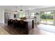 Kitchen with a large island, quartz countertops, stainless steel appliances, and an adjacent door to outdoor space at 10502 E Lakeshore Dr, Carmel, IN 46033