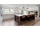 Spacious kitchen features a large dark wood island with a white countertop, pendant lights, and seating at 10502 E Lakeshore Dr, Carmel, IN 46033