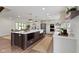 Open kitchen featuring a central island with barstool seating and seamless integration with the dining area at 10502 E Lakeshore Dr, Carmel, IN 46033