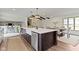 Open-concept kitchen with a large island, breakfast bar, modern finishes, and easy access to the dining area and staircase at 10502 E Lakeshore Dr, Carmel, IN 46033