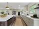 Modern kitchen featuring a central island with a farmhouse sink, quartz countertops, and stainless steel appliances at 10502 E Lakeshore Dr, Carmel, IN 46033