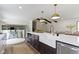 Bright, modern kitchen featuring a large island with a white farmhouse sink and a view of the adjacent staircase at 10502 E Lakeshore Dr, Carmel, IN 46033