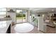 Bright kitchen area with direct access to the backyard and an open view to the living room with a fireplace at 10502 E Lakeshore Dr, Carmel, IN 46033