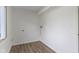 Functional laundry room with bright lighting and wood-look floors at 10502 E Lakeshore Dr, Carmel, IN 46033