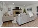Inviting living room featuring a stone fireplace and wood-look flooring at 10502 E Lakeshore Dr, Carmel, IN 46033